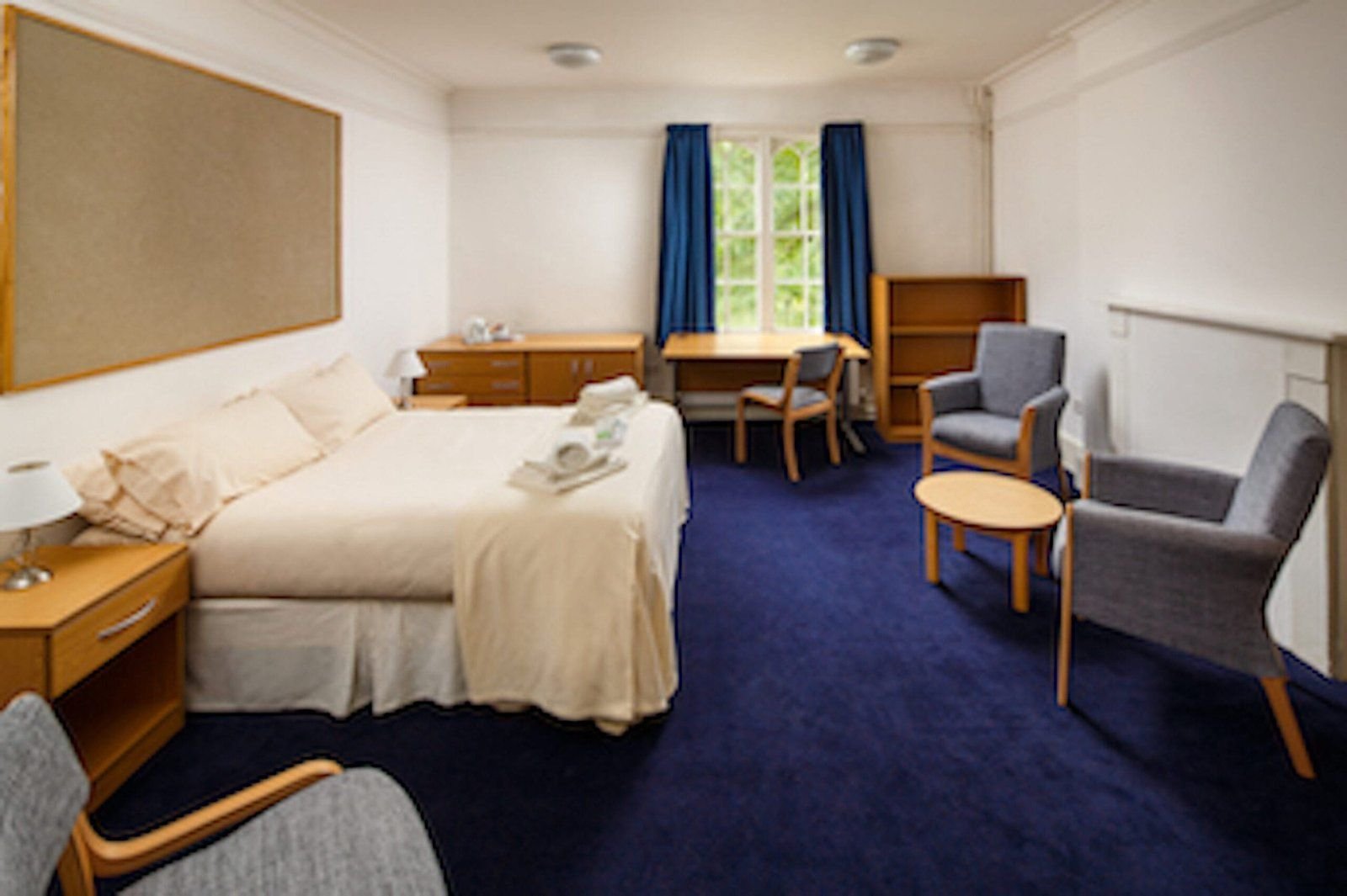 Superior double room at Christ’s College, Cambridge, with a desk and chairs by the window.