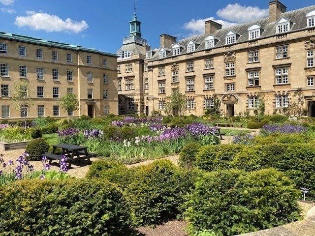 Third Court at Christ’s College, Cambridge, full of white and purple irises in early summer.