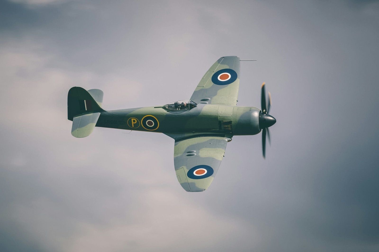 WWII airfields around Cambridge: A wartime plane flying in the sky.