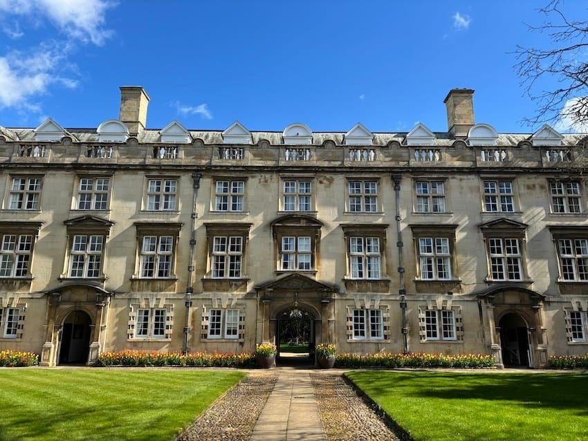 Second Court at Christ’s College, Cambridge, in the sunshine with a border of yellow and orange tulips.