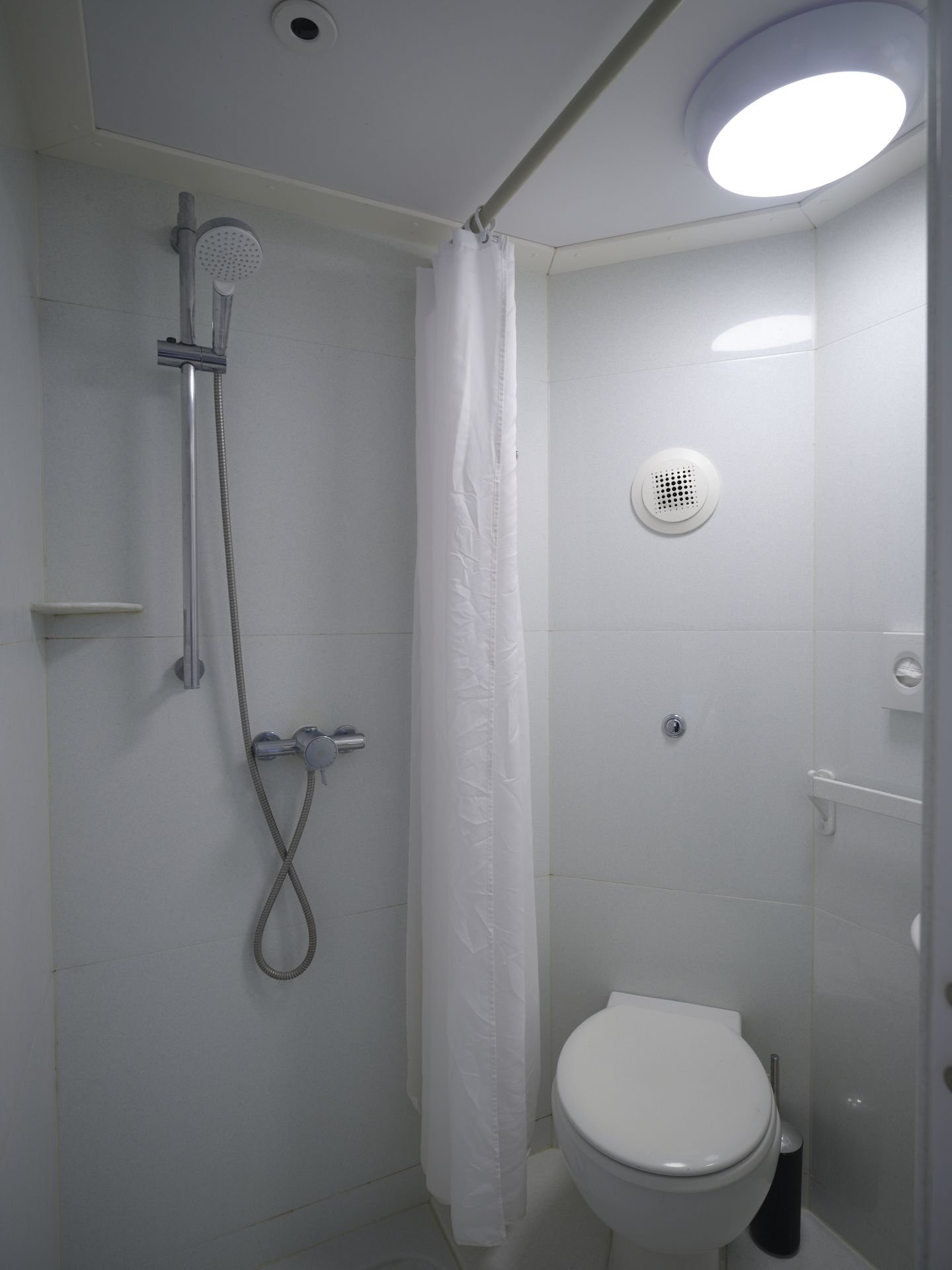 The shower pod in a single ensuite room at Christ's College, Cambridge, with shower, basin and toilet.