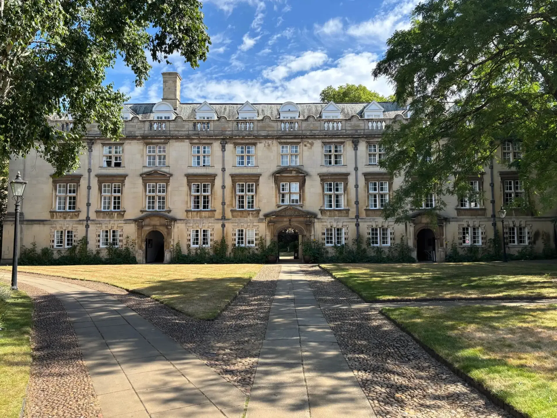 First Court at Christ’s College, Cambridge, with its circular lawn and historic stone buildings in the sunshine.