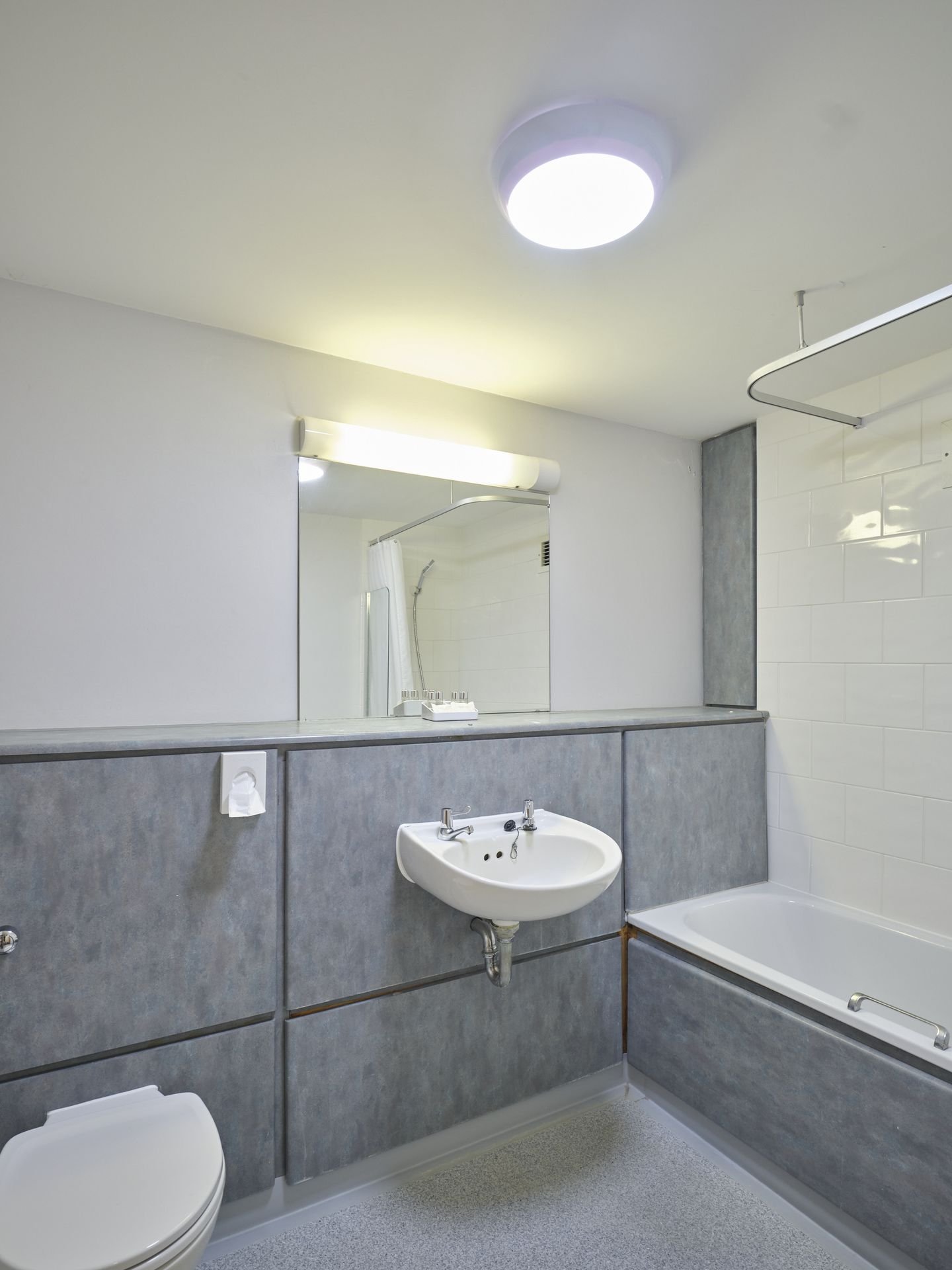 The ensuite bathroom in a twin room at Christ's College, Cambridge, with a bath, shower and basin.