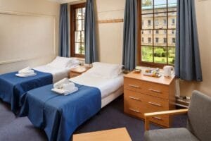 Planning a Citybreak in Cambridge 3 Twin bedroom at Christ's College featuring two beds and a bedside table. A Cambridge bed and breakfast.