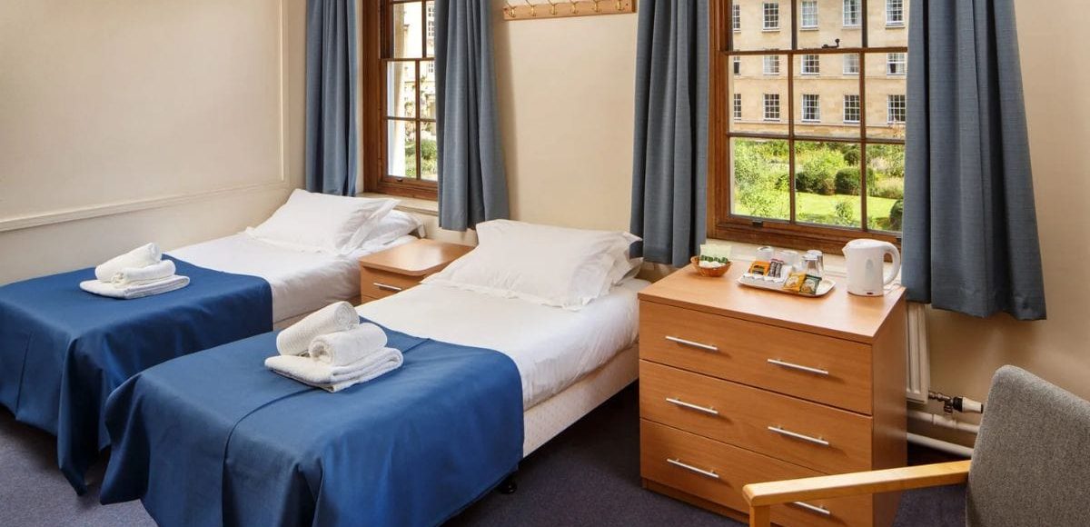 Twin shared bathroom new2 Twin bedroom at Christ's College featuring two beds and a bedside table
